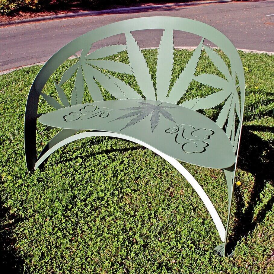 terra verge green cannabis leaf metal garden bench on grass