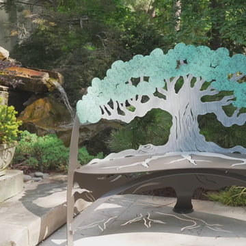 video of tree bench close up metal tree backrest branching detail sculptural outdoor bench craftsmanship garden seating design